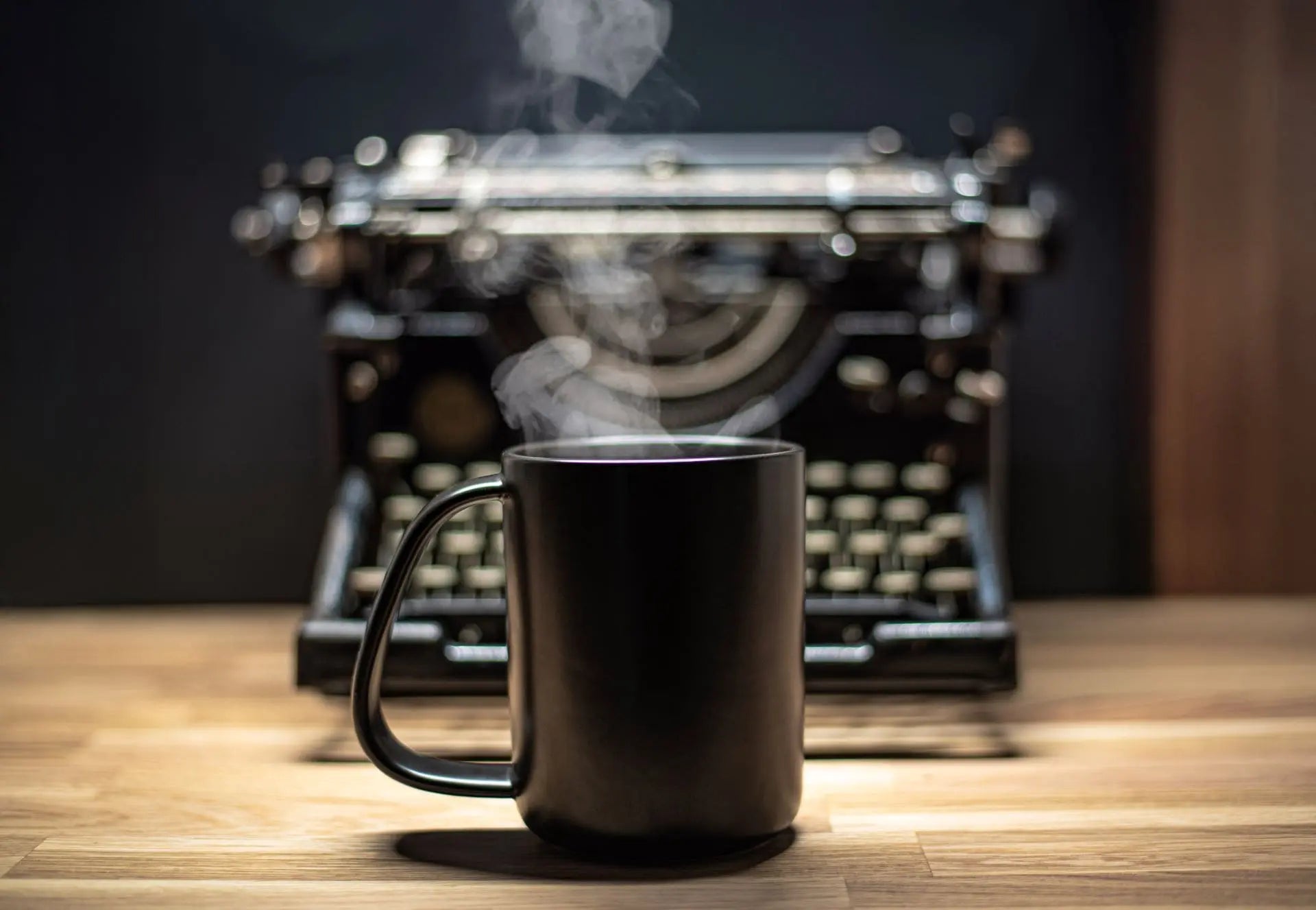 Black CURVD mug in front of underwood No5 typewriter